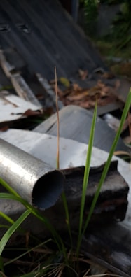 Close-up of a drain snake tool removing debris from a pipe