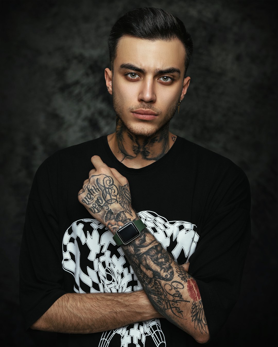man in black crew neck t-shirt with black and white skull tattoo on his right
