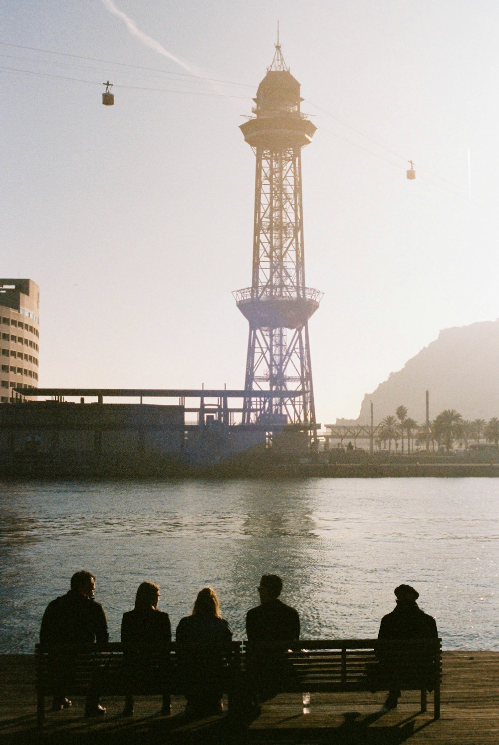 silhouette of people near body of water during daytime