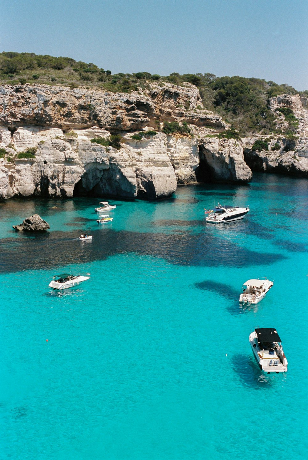 white and blue boat on water during daytime