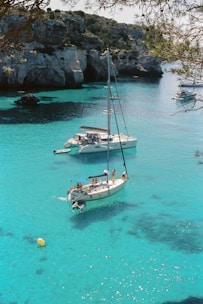 white and blue boat on sea during daytime
