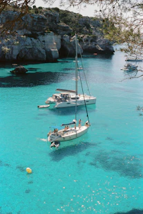 white and blue boat on sea during daytime