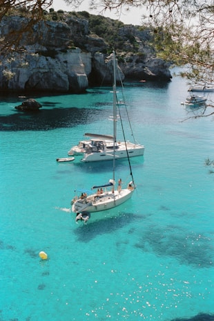 white and blue boat on sea during daytime