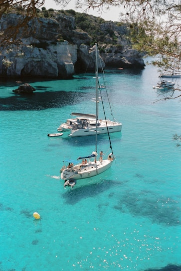 white and blue boat on sea during daytime