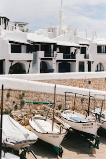 white and blue boat on white sand beach during daytime