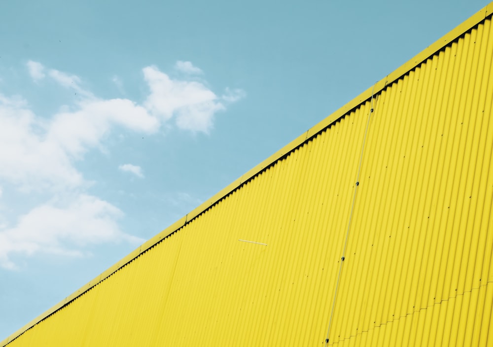 yellow metal fence under blue sky during daytime