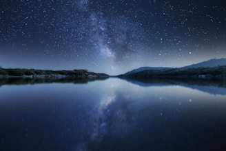 body of water under starry night
