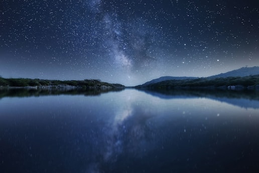 body of water under starry night