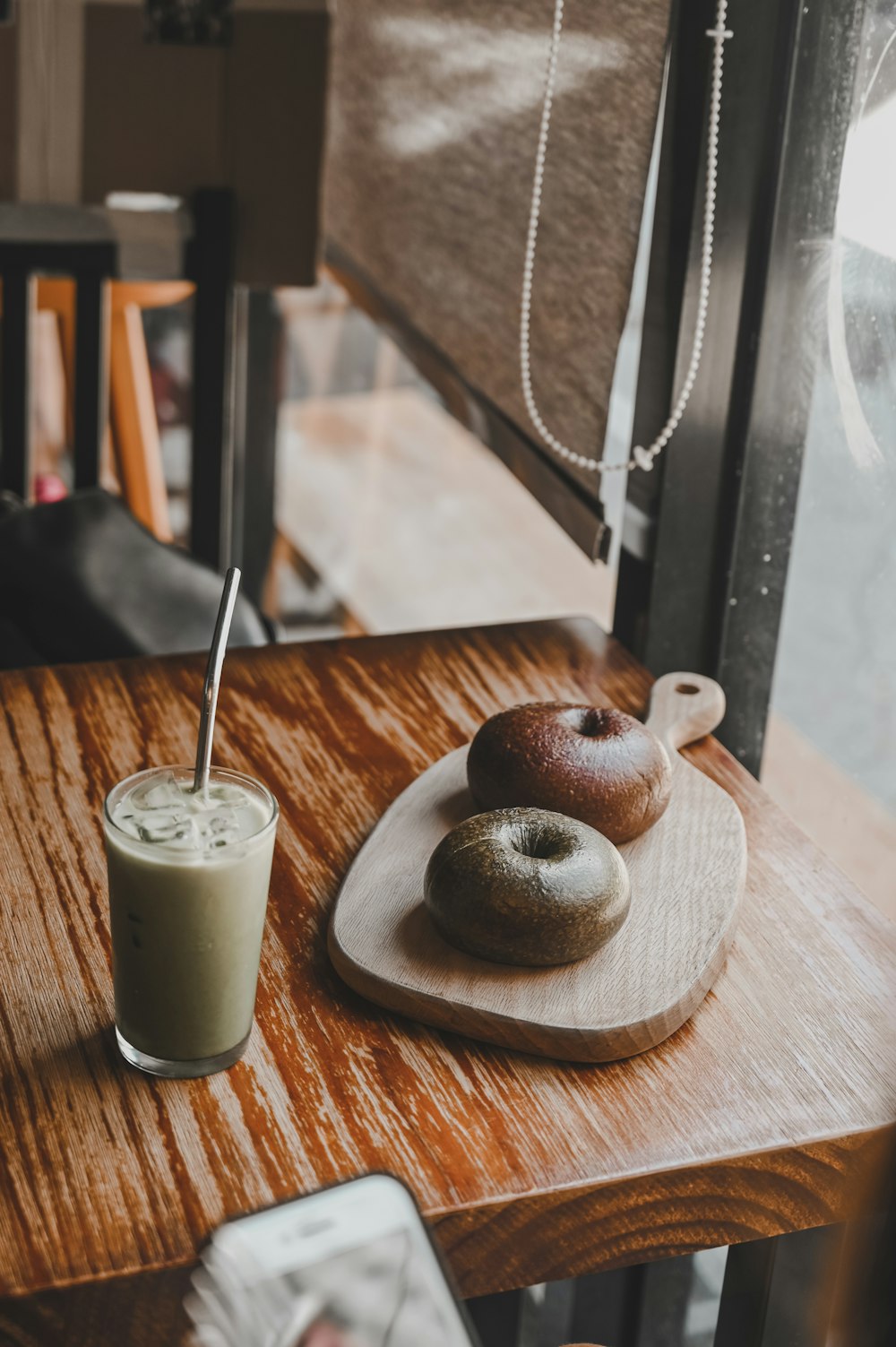 white liquid in clear drinking glass on brown wooden table