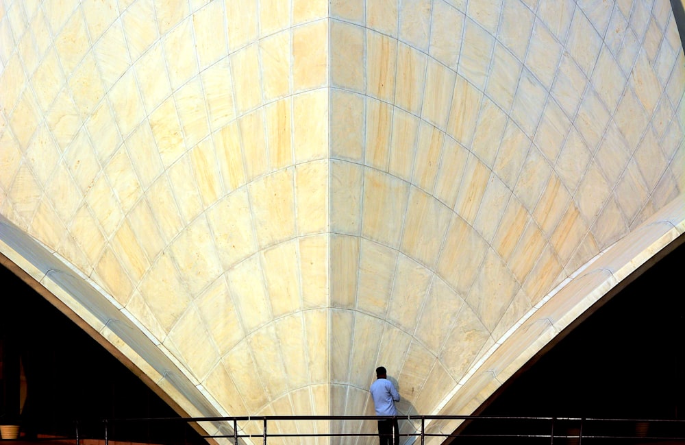 man in white shirt standing on stairs