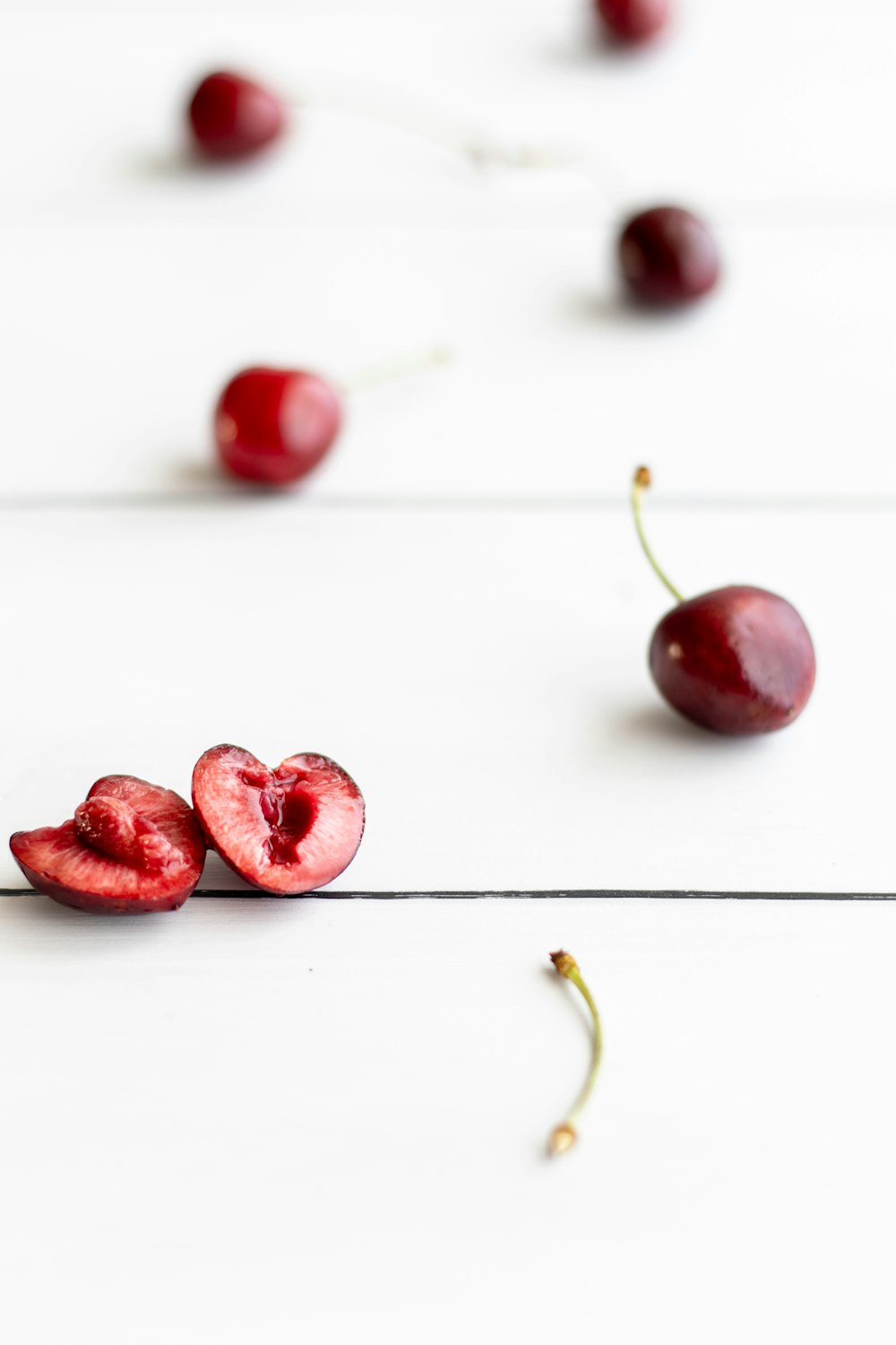 red round fruits on white surface