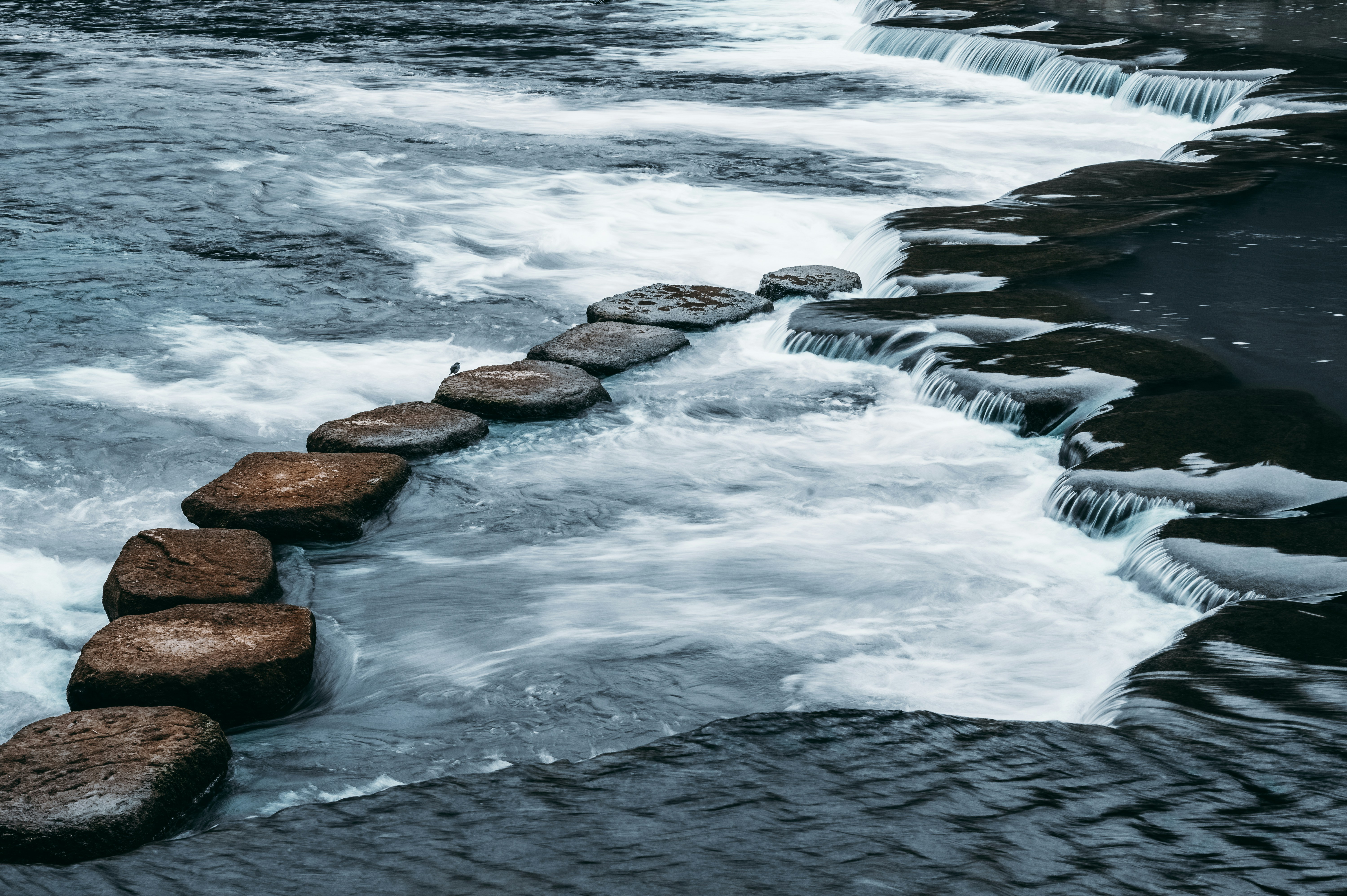 water waves hitting rocks during daytime