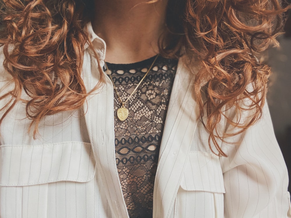 woman in white blazer and black and white polka dot shirt