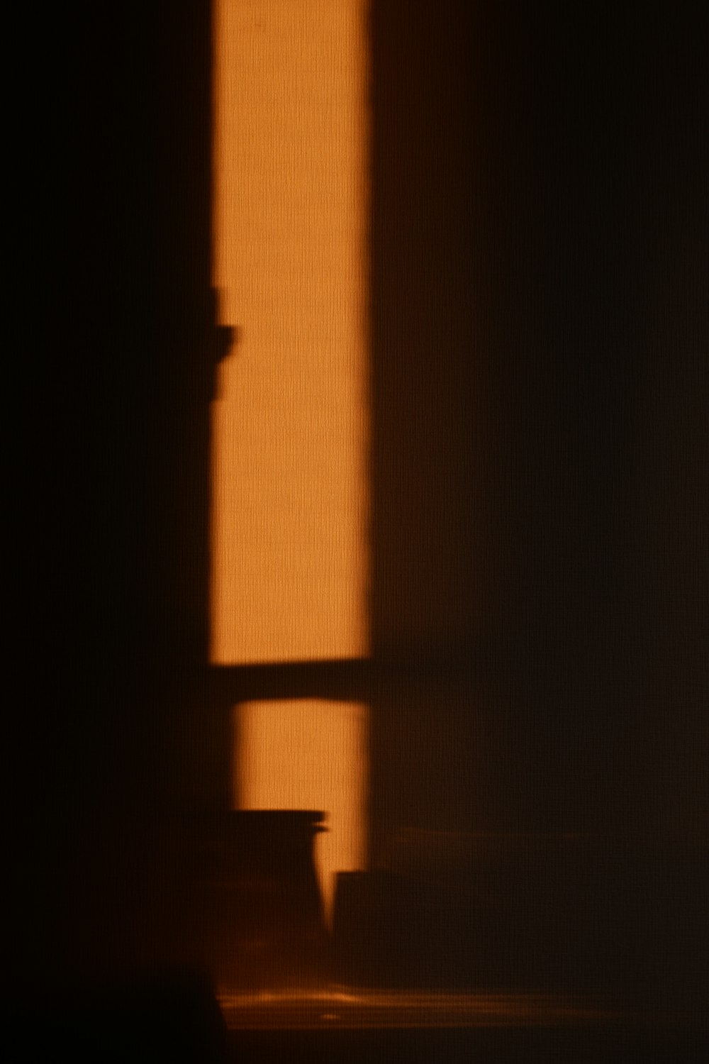 silhouette of a person standing on a dark room