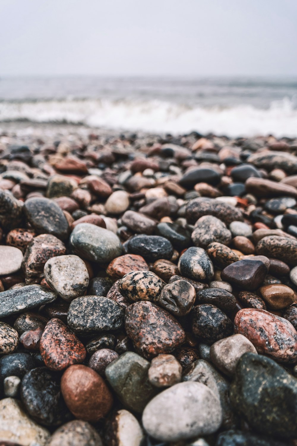 black and gray stones near sea during daytime