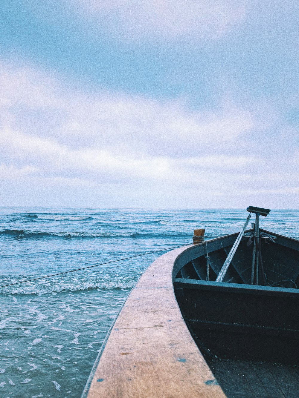 brown wooden boat on sea during daytime