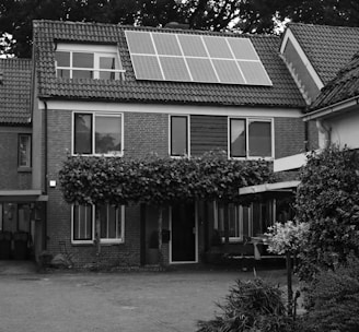 grayscale photo of 2 storey house