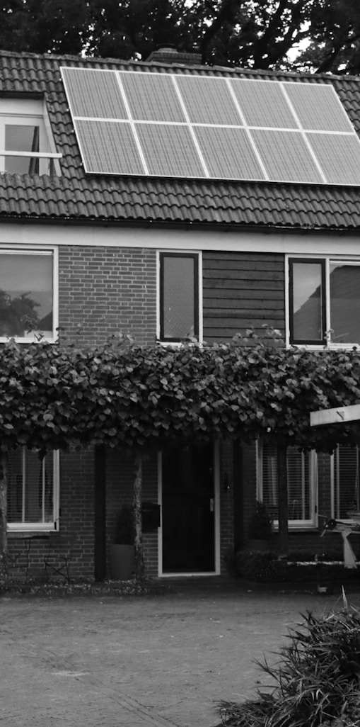 grayscale photo of 2 storey house