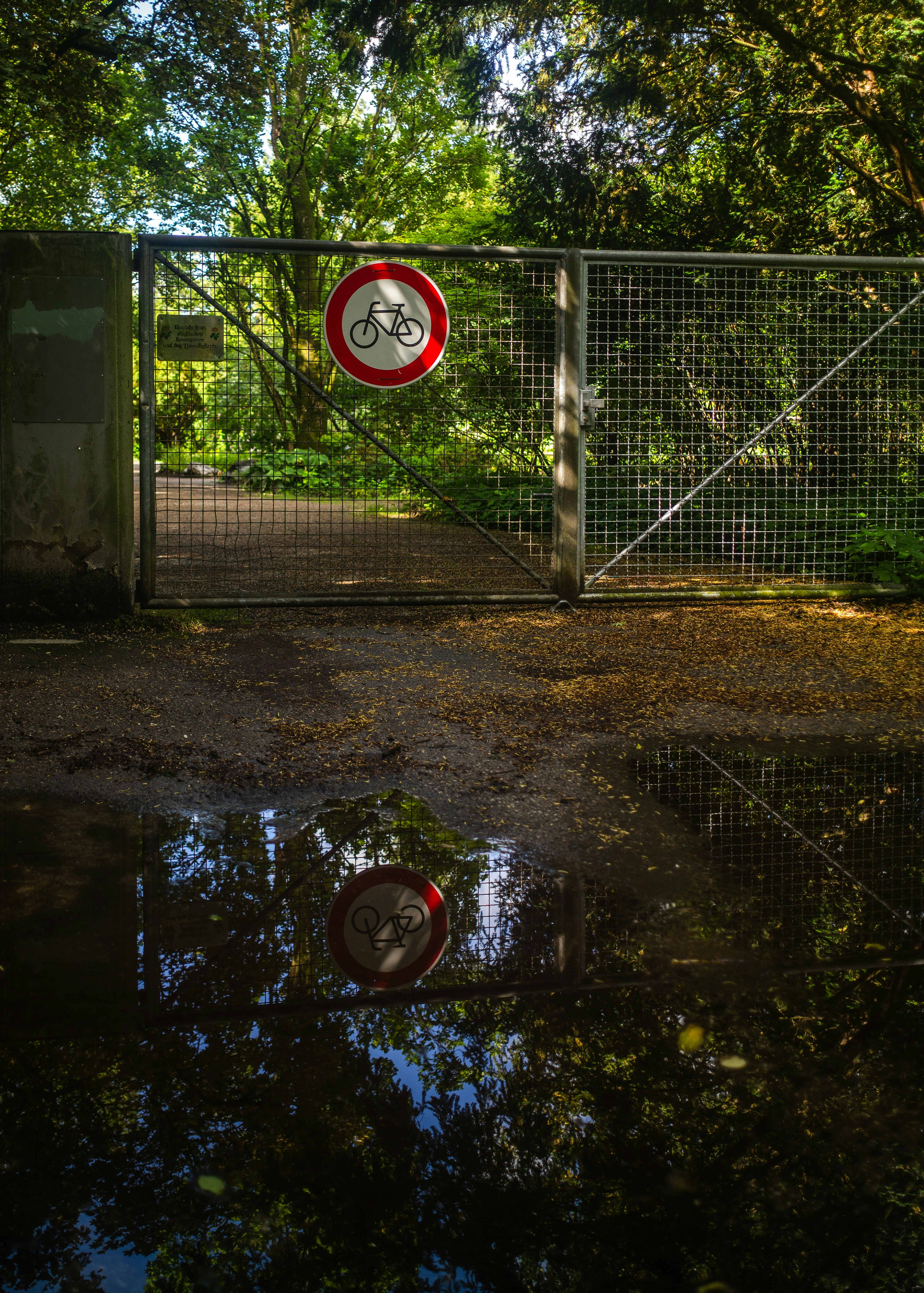 closed entrance to a park in munich with bicycle ban sign