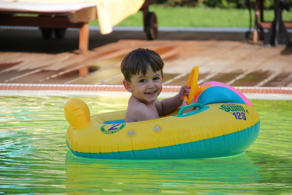 baby in red tank top on inflatable float