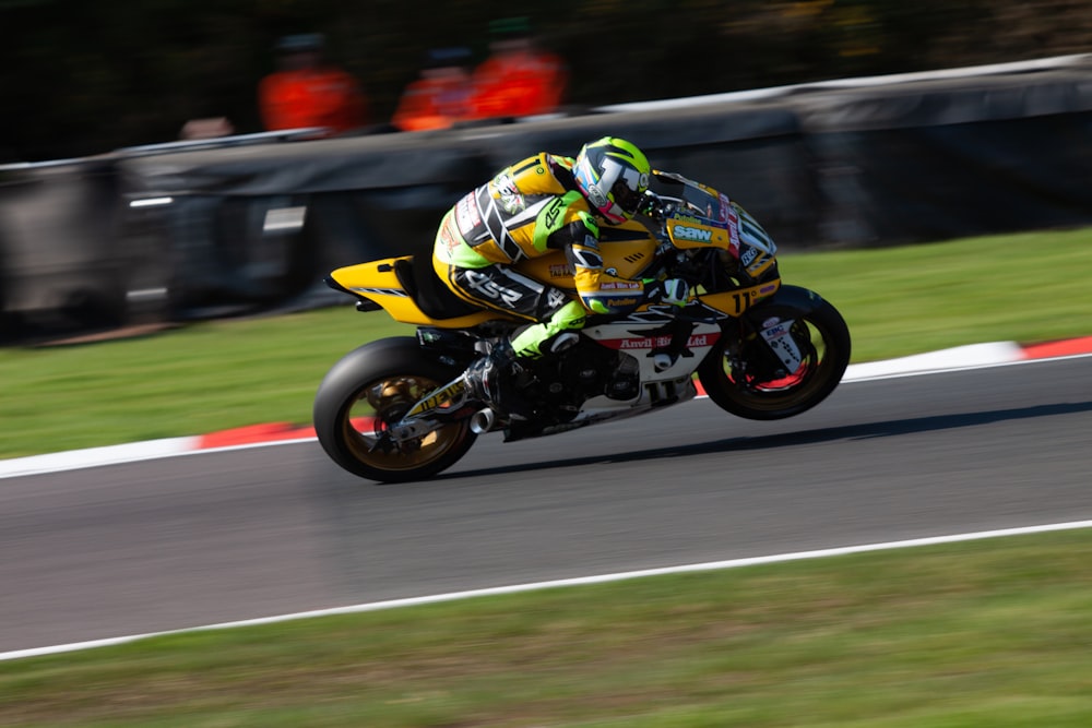 man in green and black motorcycle suit riding on motorcycle