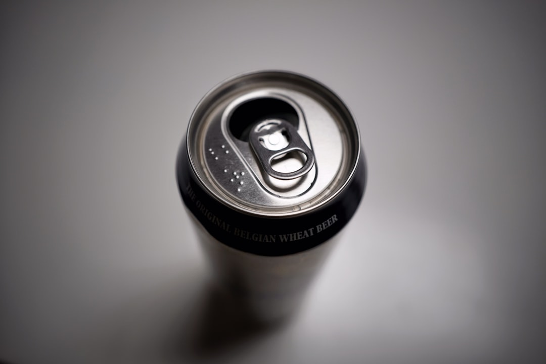 black and silver can on white table