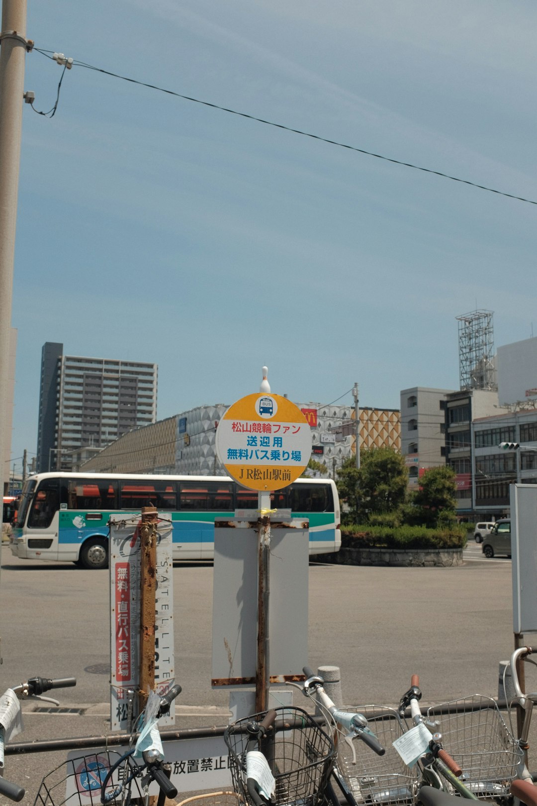 white and yellow street sign near white and brown concrete building during daytime