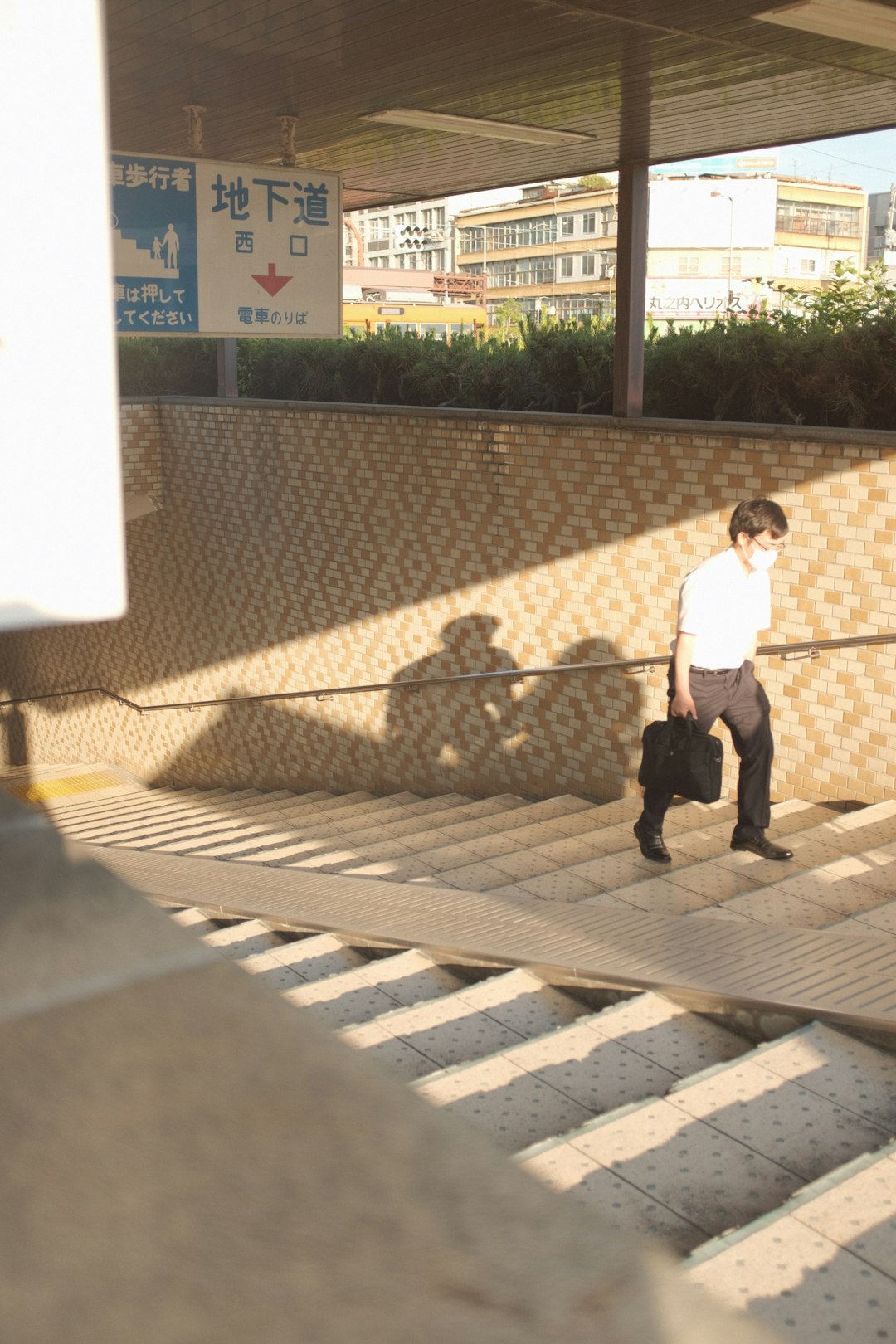 girl in white shirt and black pants walking on sidewalk during daytime