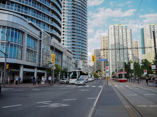 cars on road near high rise buildings during daytime in Lower Simcoe Street Canada