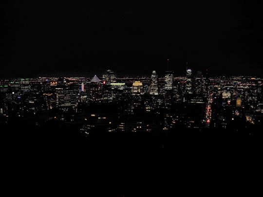 city with high rise buildings during night time in Mount Royal Park Canada