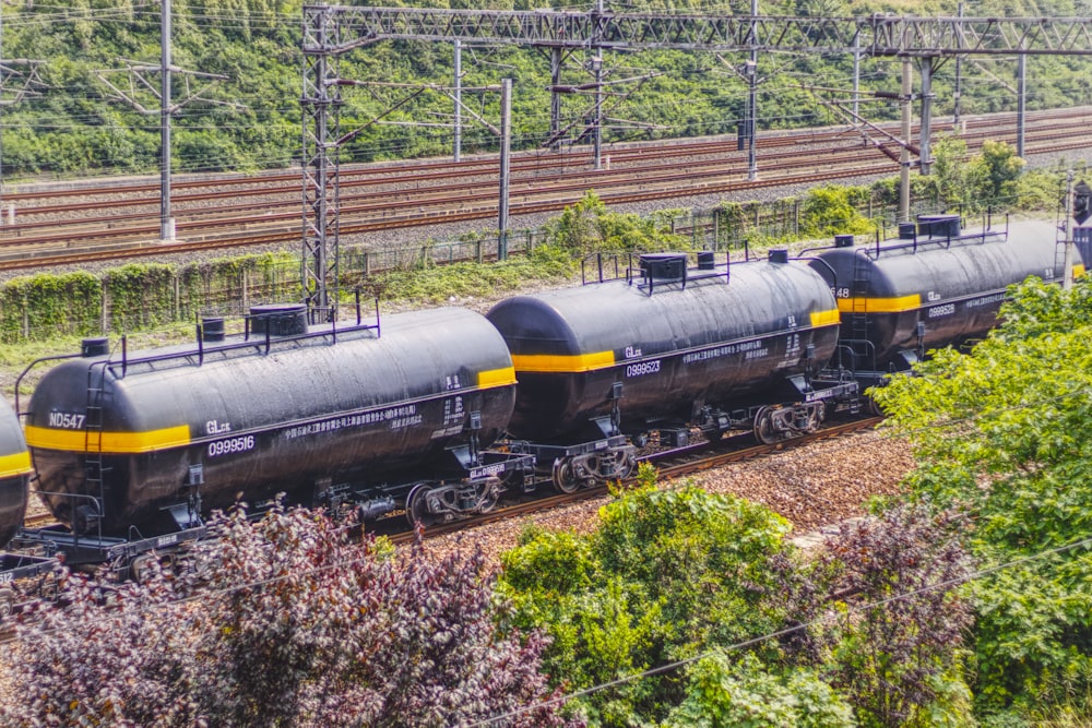 black train on rail tracks during daytime