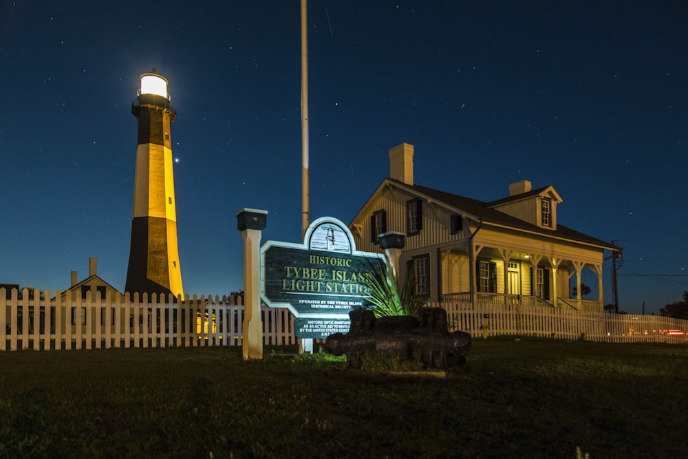 white and brown concrete building near green grass field during night time