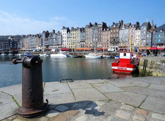 red and white boat on water near buildings during daytime in Port of Honfleur France