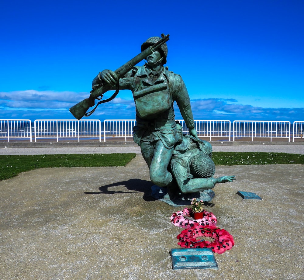 statue of man holding red bouquet