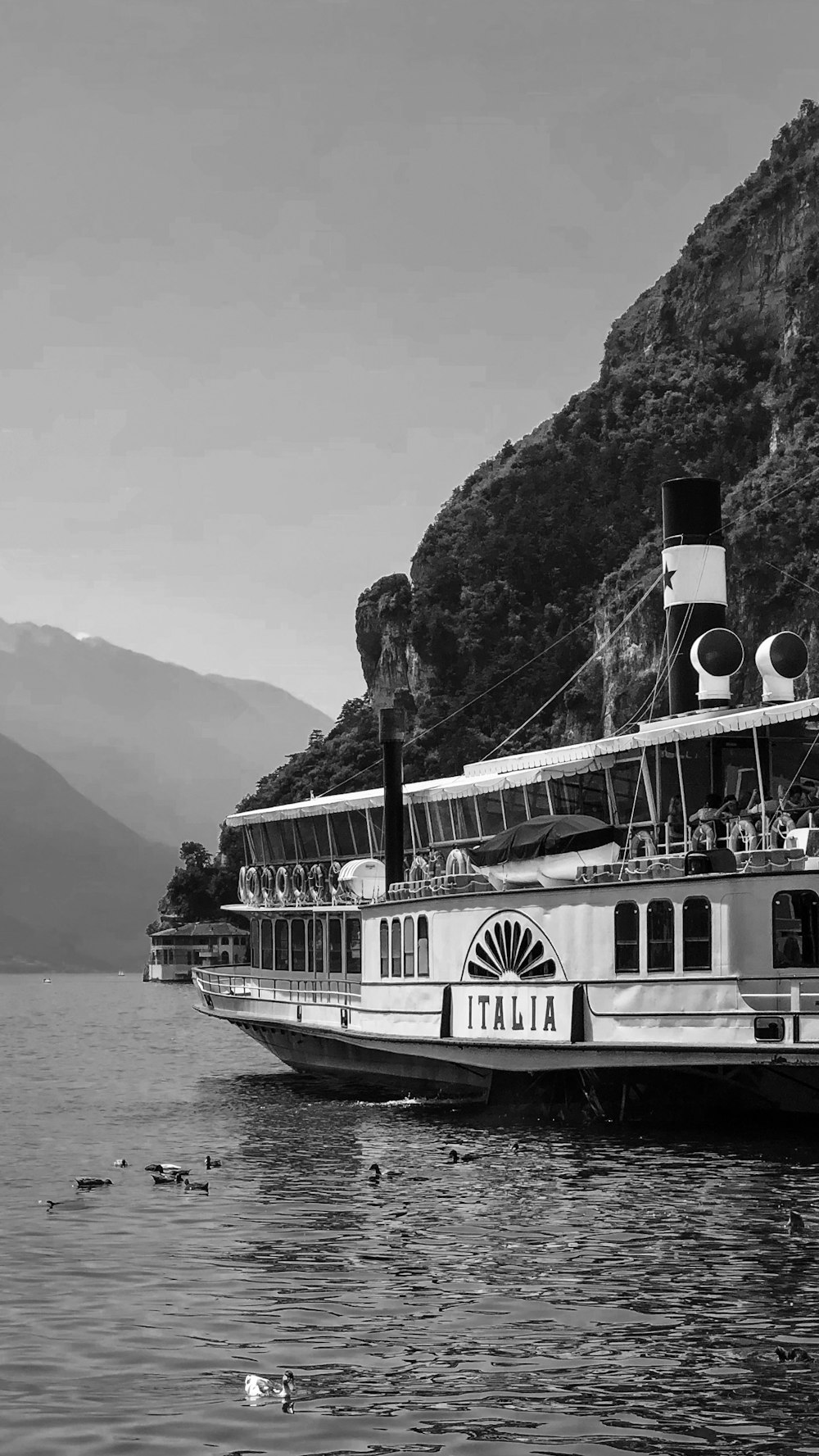 grayscale photo of white ship on sea