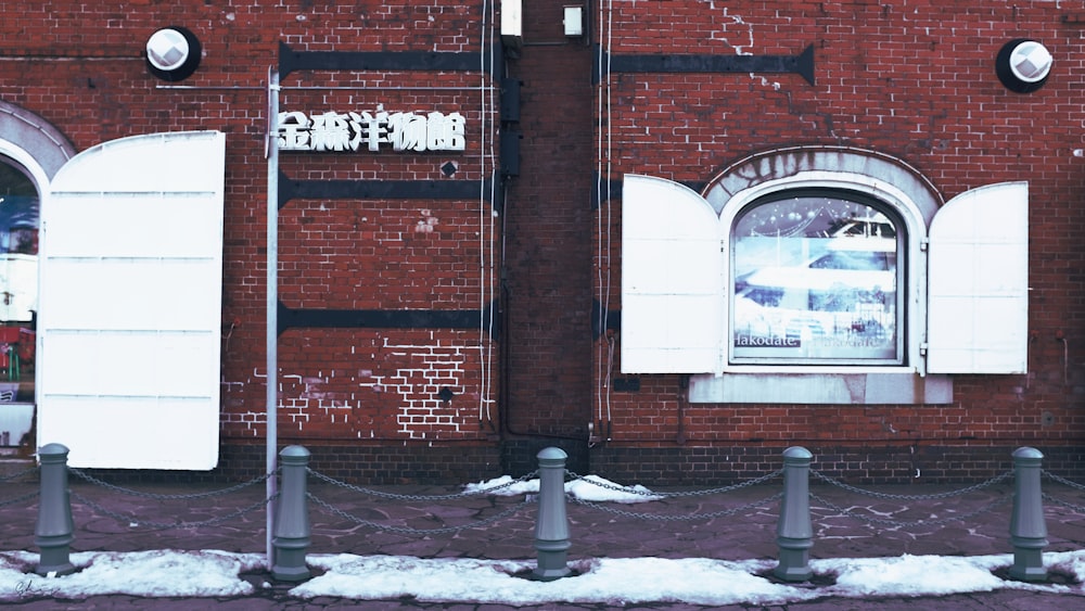 brown brick building with snow covered ground