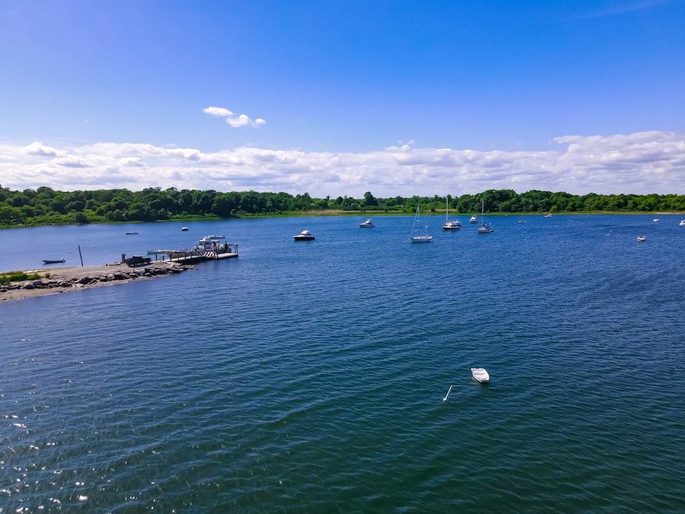 white boat on sea under blue sky during daytime