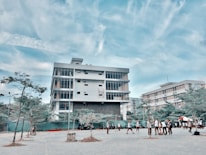 Modern university building with students walking in front.