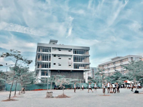 A scenic view of a modern North American university building with students walking by.