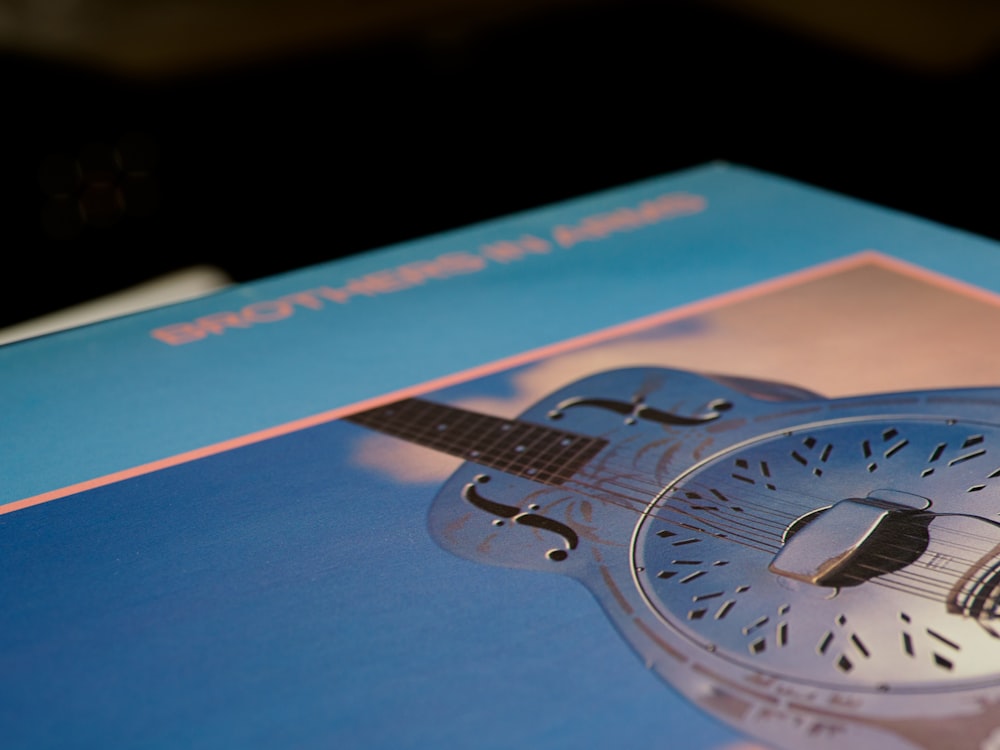 blue and orange book with clock print