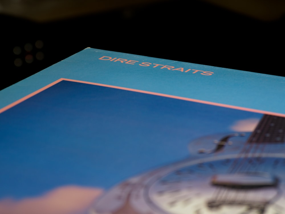 blue and white book on black table