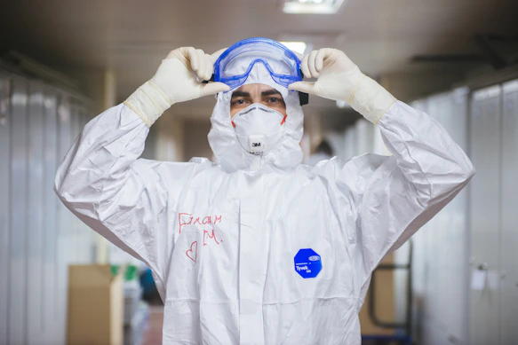 Technician in a white protective suit and goggles ready for mold remediation