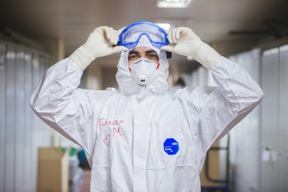 Person in weißer und blauer Maske und weißem Langarmhemd