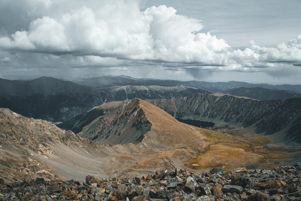 rocky mountain under white clouds during daytime