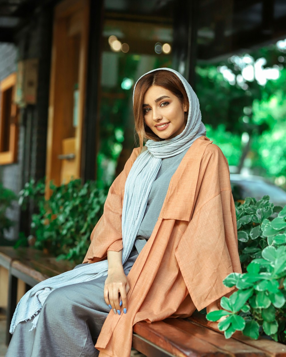 woman in brown hijab sitting on ground