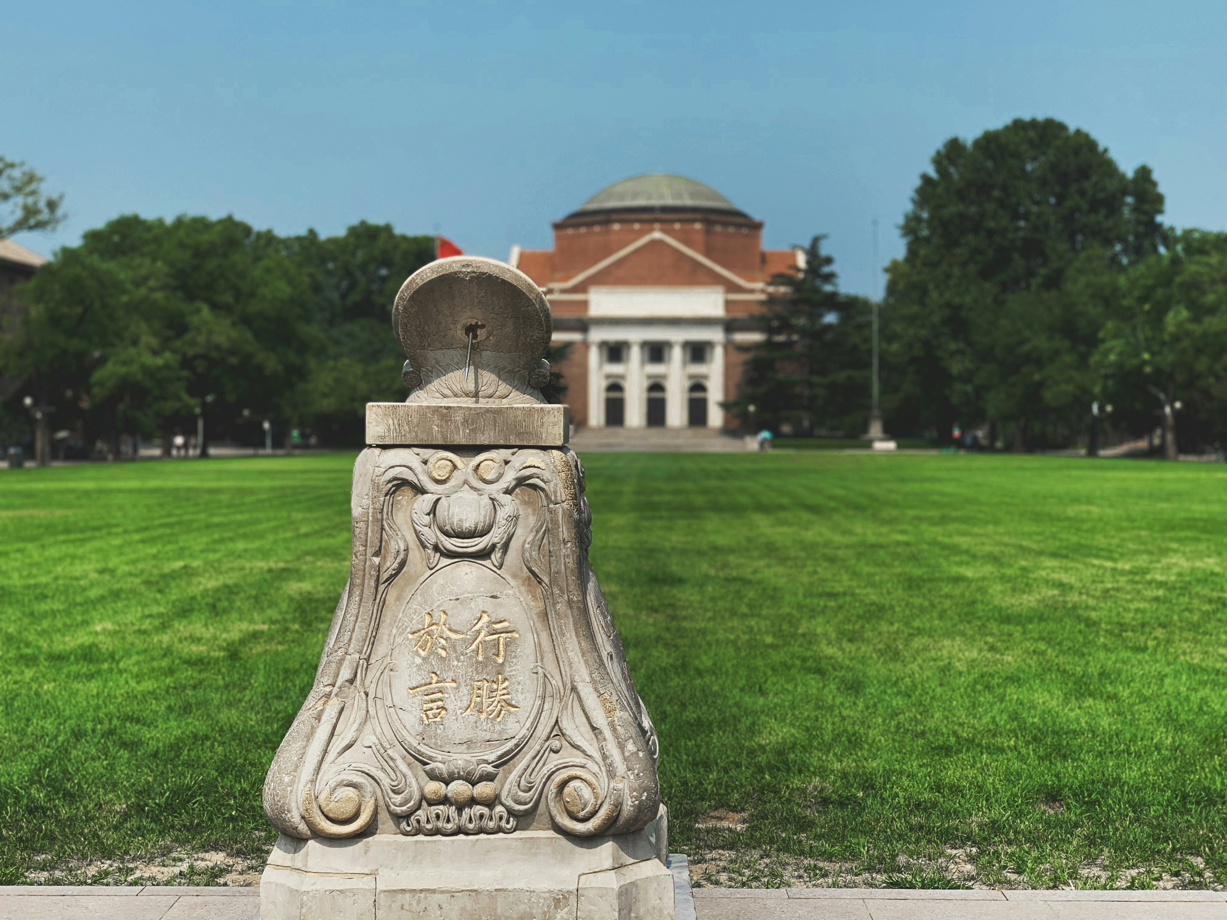 grey concrete statue on green grass field during daytime