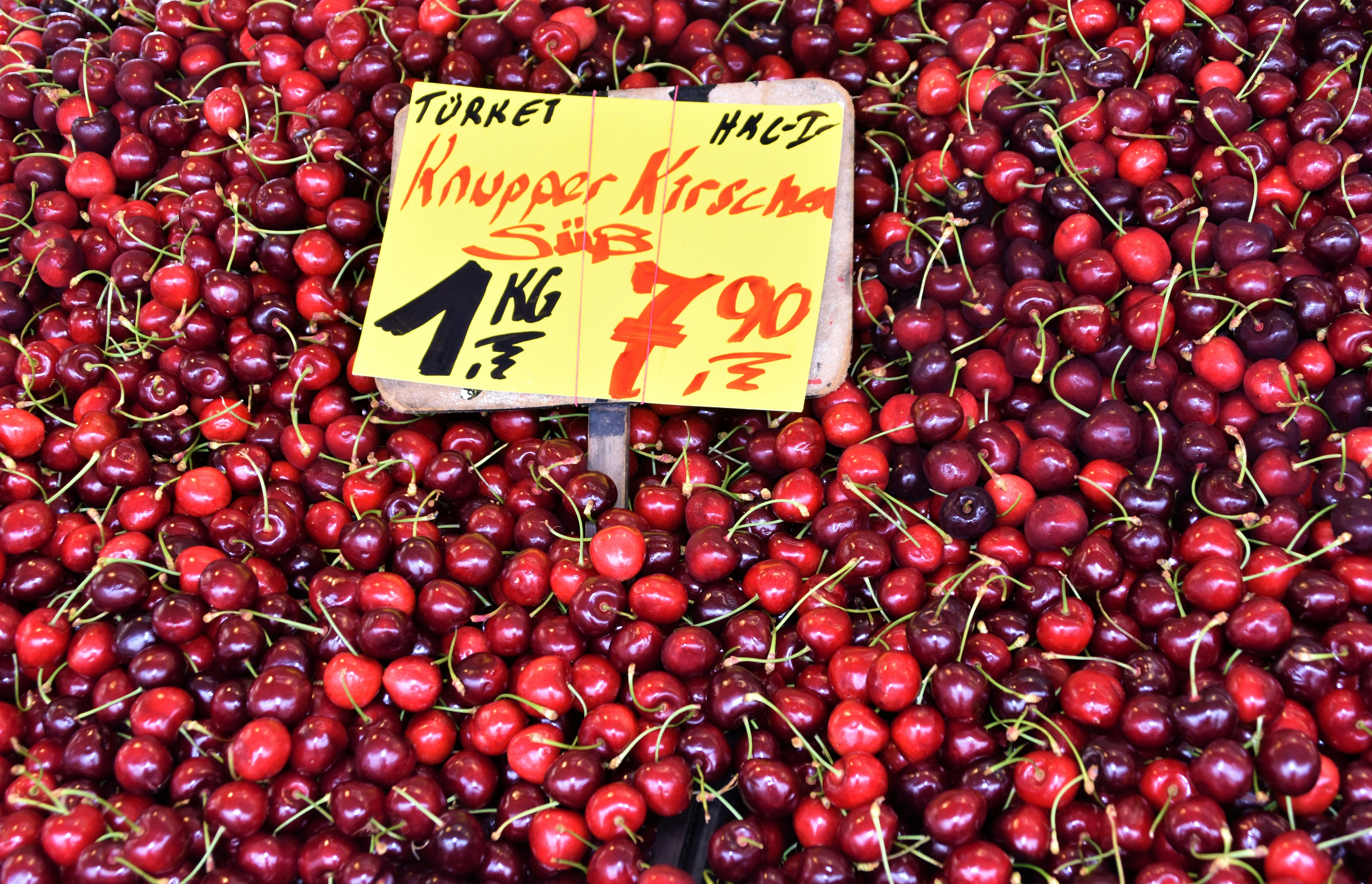 The first cherry fruits on the market stand of a fruit market
