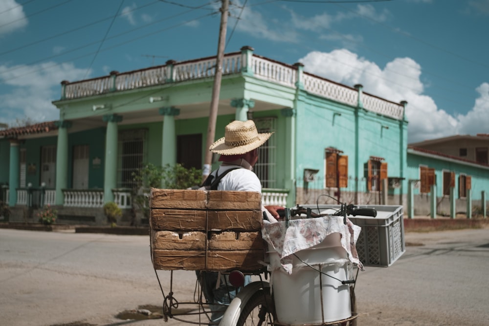 person in brown hat riding on bicycle during daytime