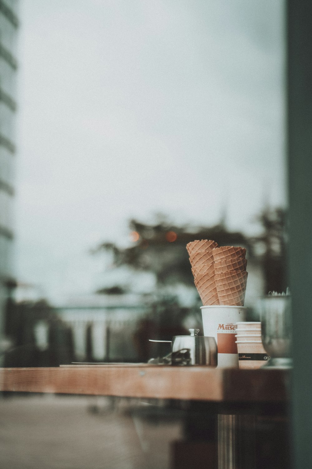 brown and white plastic cups on brown wooden table