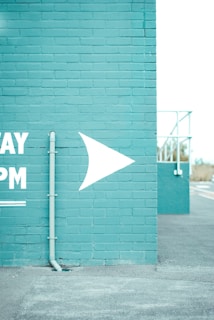 blue and white arrow and sign